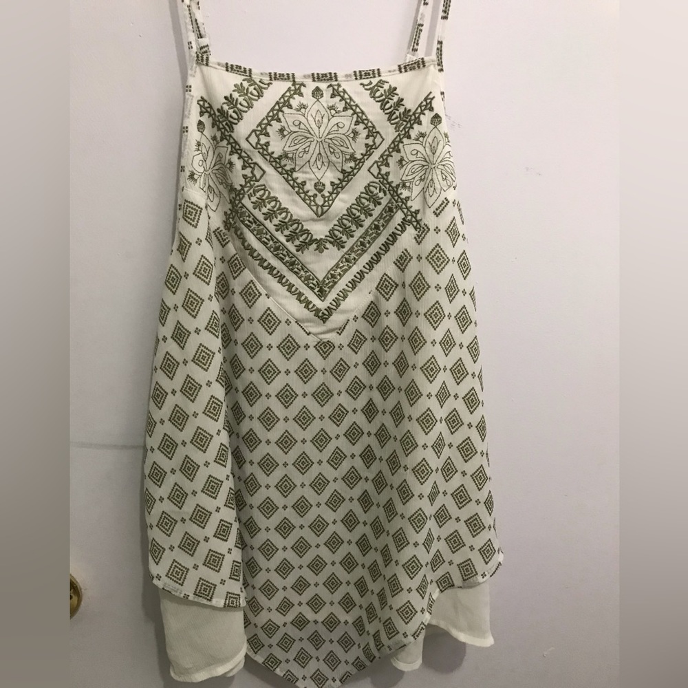 White top with a unique olive green pattern
